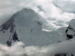 
The next morning we started our trek from Shagring Camp to Gasherbrum Base Camp in mostly cloudy weather. After 30 minutes we reached �Gasherbrum Corner� at the junction of the Upper Baltoro Glacier with the tributary Abruzzi Glacier. Gasherbrum I and Gasherbrum I South lie straight ahead. Gasherbrum I (8080m) is the 11th highest mountain in the world. Gasherbrum I was first climbed by July 5, 1958 by Americans Pete Schoening and Andy Kauffman. Gasherbrum I South (7069m) was first climbed by Maurice Barrard and Georges Narbaud via the Southwest Ridge in July 1980 on their ascent of Gasherbrum I
